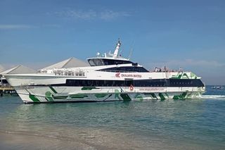 Ekajaya Matra fast ferry moored off the beach