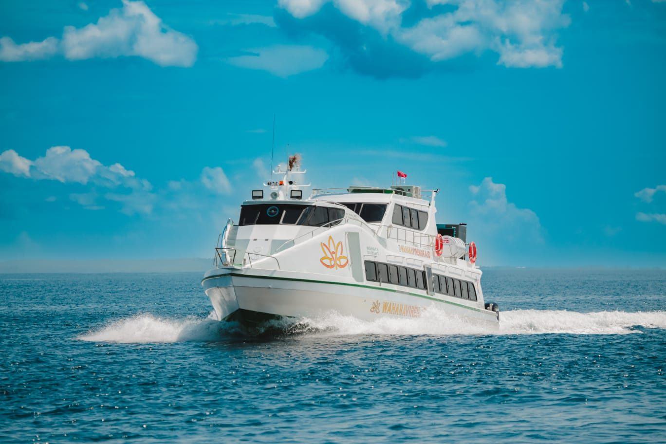 Fast ferry under way on calm turquoise water