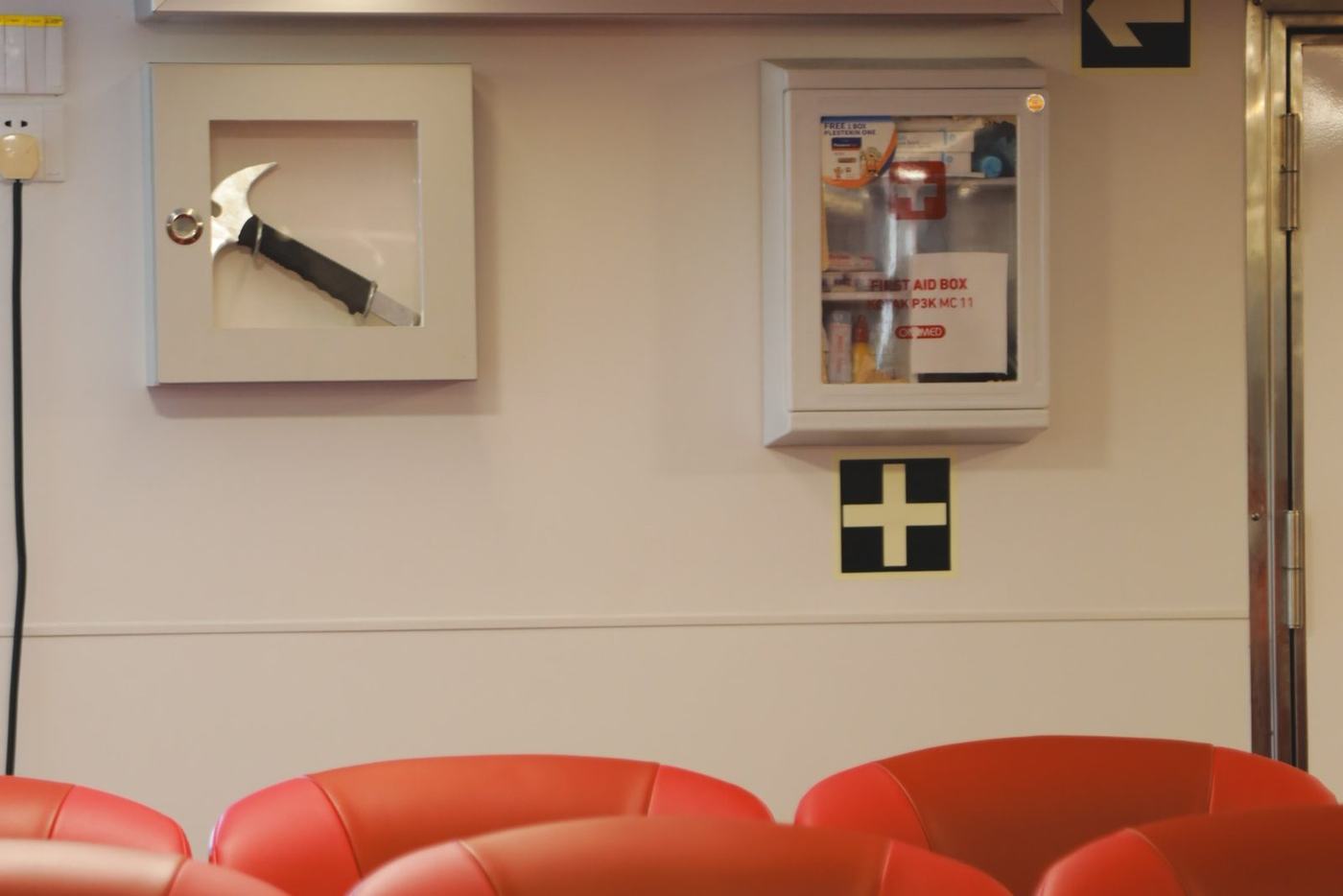 Cabin wall with the clock, notices and first aid box