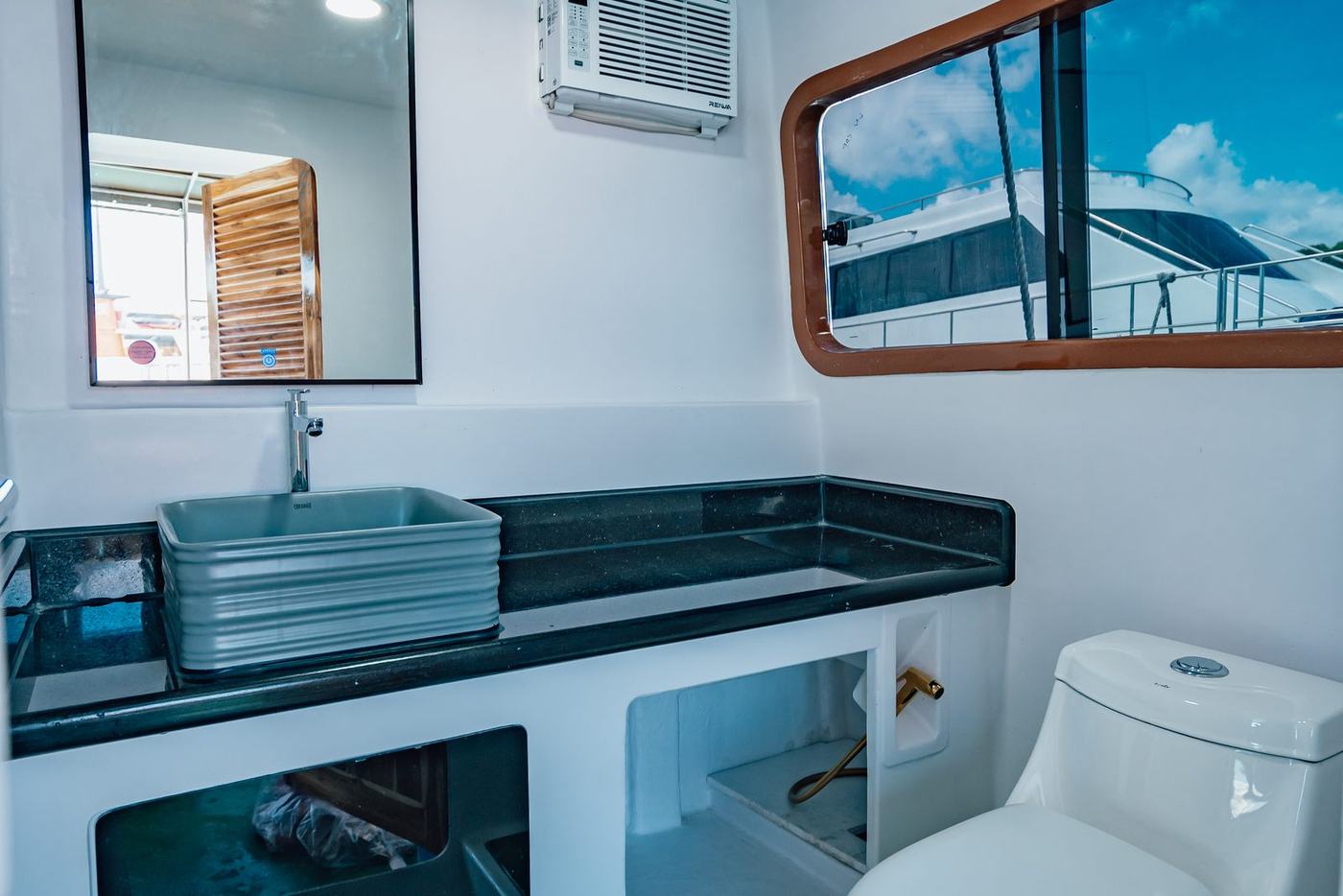 Onboard washroom with mirror, basin and window
