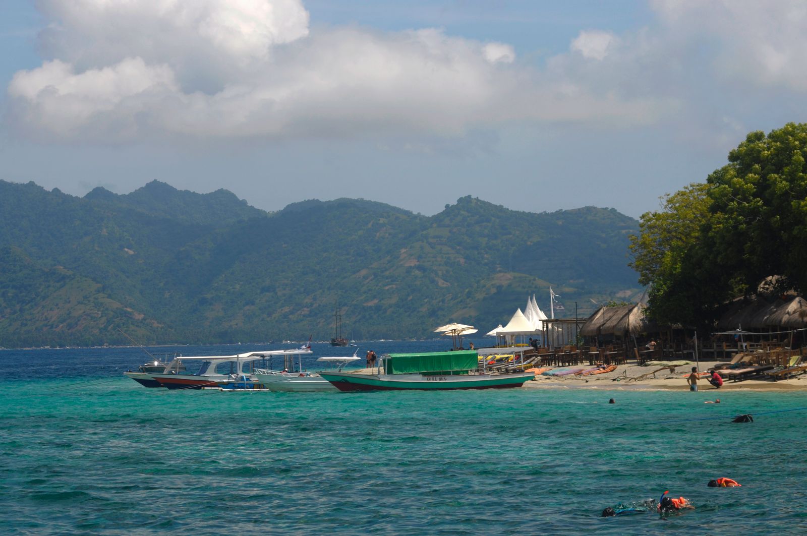Boats moored off a Gili island beach with Lombok behind