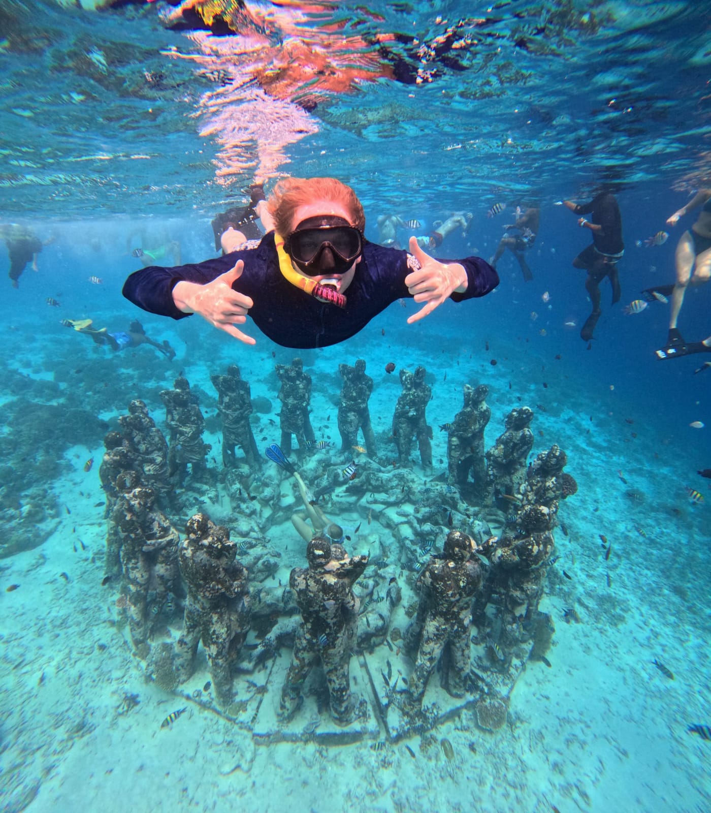 Snorkeller above The Nest underwater statues off Gili Meno