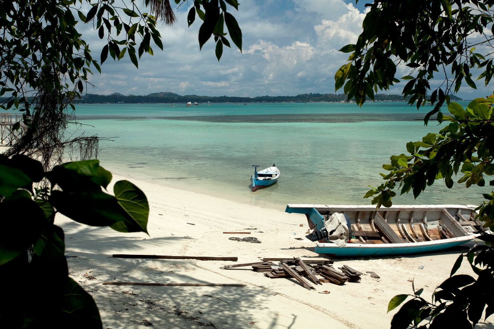 Quiet white-sand beach and clear shallows on a Gili island