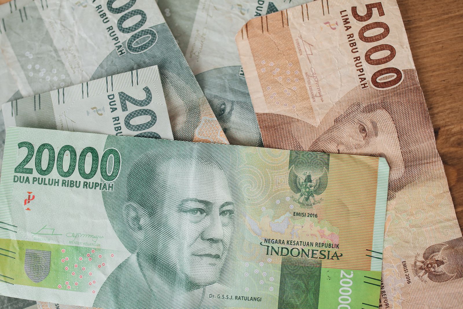 Indonesian rupiah banknotes counted out by hand