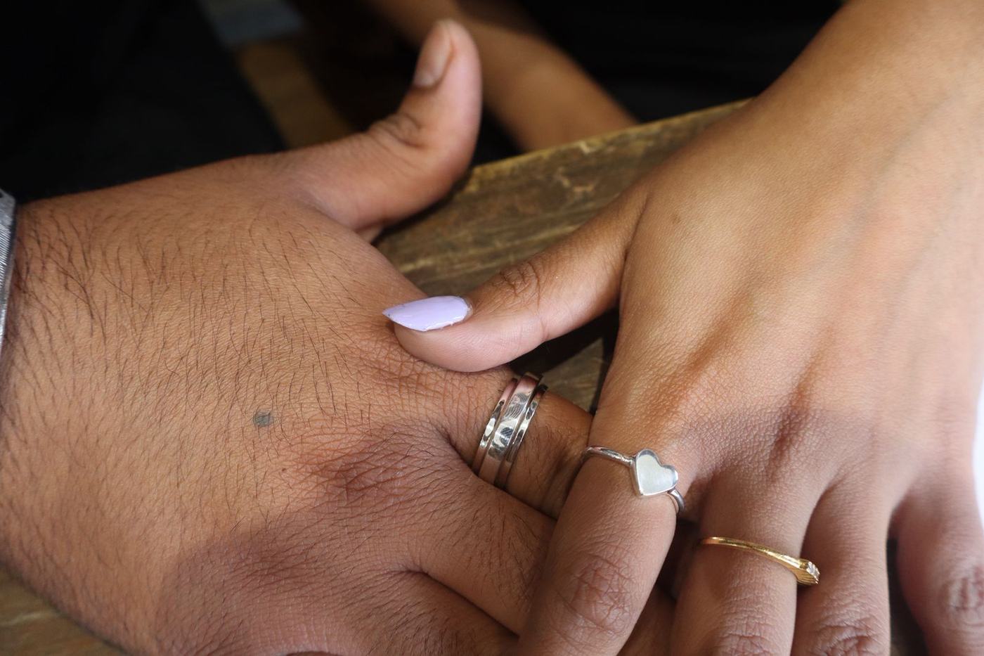 A guest's hands with the silver ring they have just finished