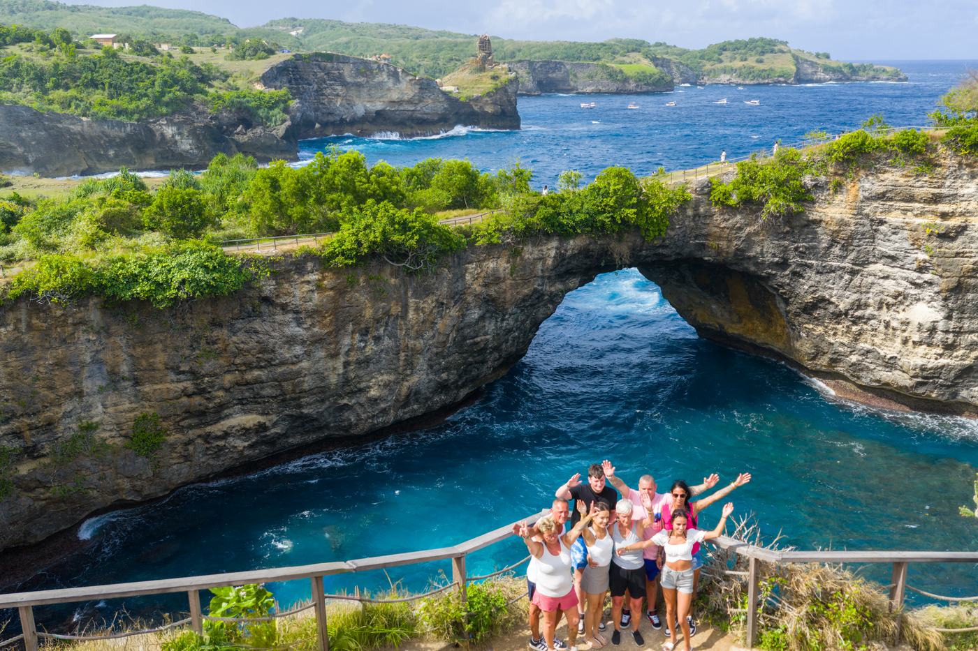 Boat of visitors under the arch at Broken Beach