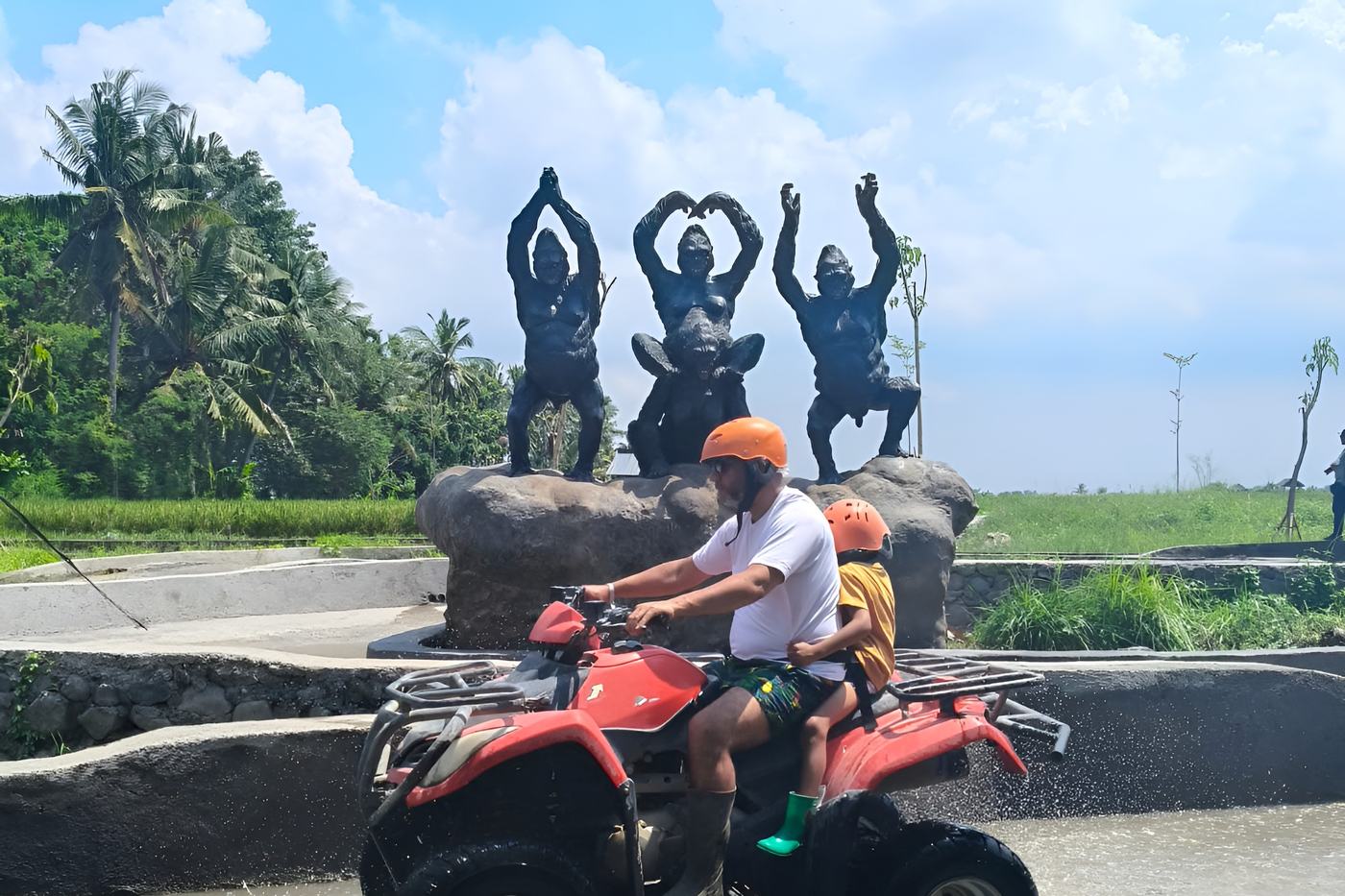 Guests on ATVs at the statue by the track entrance